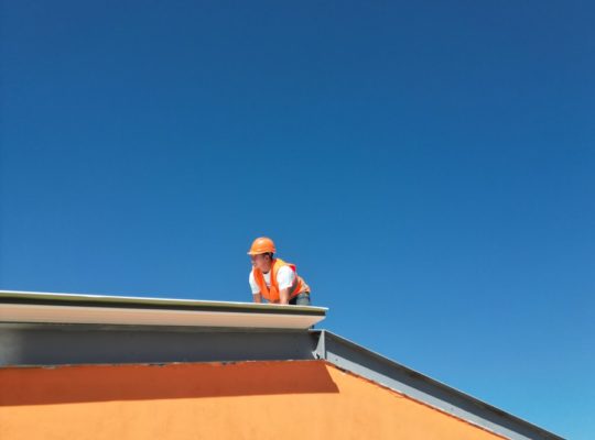 A man standing on top of a roof