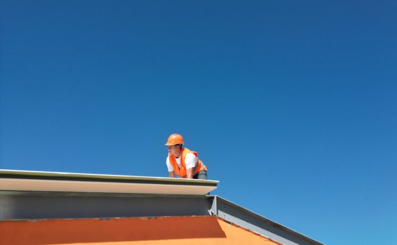 A man standing on top of a roof